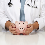 Doctor holding a piggy bank