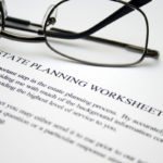 Estate planning worksheet with glasses on top of document