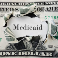 A dollar with medicaid word inside