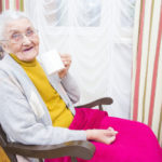 Elderly woman sitting down