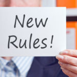 Sign that reads "New Rules!" Sign that reads "New Rules!"