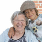 A ward, the little boy, hugging his guardian, an older lady A ward, the little boy, hugging his guardian, an older lady
