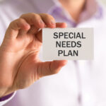 Businessman holding a card with SPECIAL NEEDS PLAN message