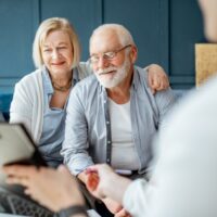 Senior couple with consultant at the office