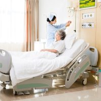 Nurse helping patient changing IV drop