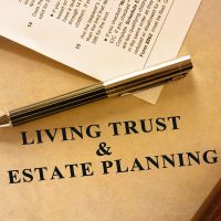 Living trust and estate planning document. A tax form is also included in the scene.