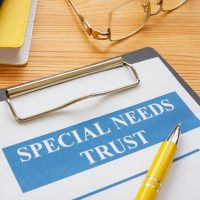Special needs trust application with clipboard and notepad.