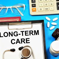 Long-term care. A text label in the planning folder. A health care payment program that ensures well-being.