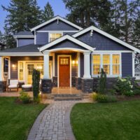 Beautiful home exterior in evening with glowing interior lights