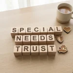 Wooden cubes spelling 'Special Needs Trust' displayed on desk